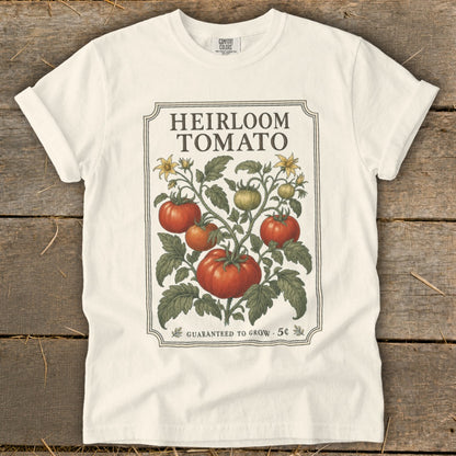 White t-shirt with "Heirloom Tomato" text and illustration of tomato plant.