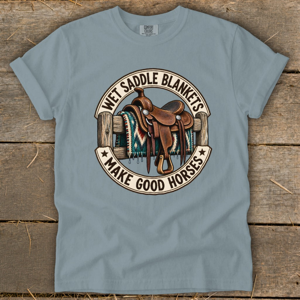 Western saddle on a fence with a blanket, text "Wet Saddle Blankets Make Good Horses".