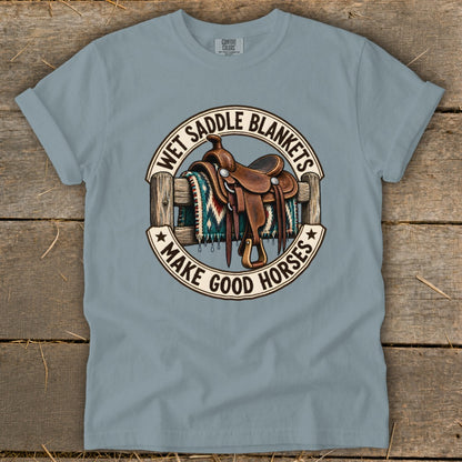 Western saddle on a fence with a blanket, text "Wet Saddle Blankets Make Good Horses".