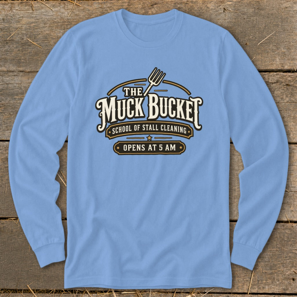 Light blue long sleeve shirt with "The Muck Bucket School of Stall Cleaning Opens at 5 AM" graphic.