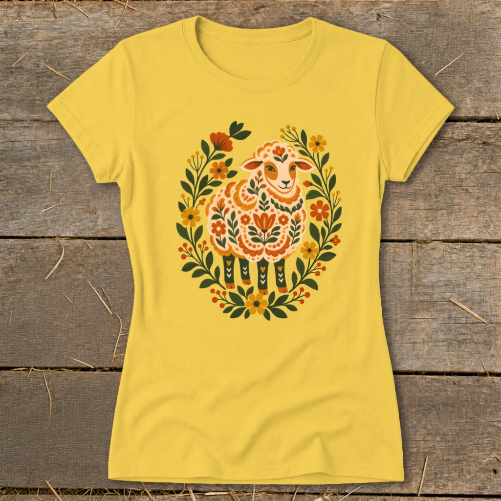 Yellow t-shirt with a decorative sheep surrounded by a floral wreath.