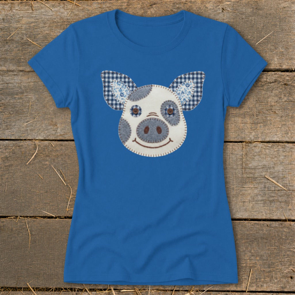 Blue t-shirt with a pieced-together pig face applique.