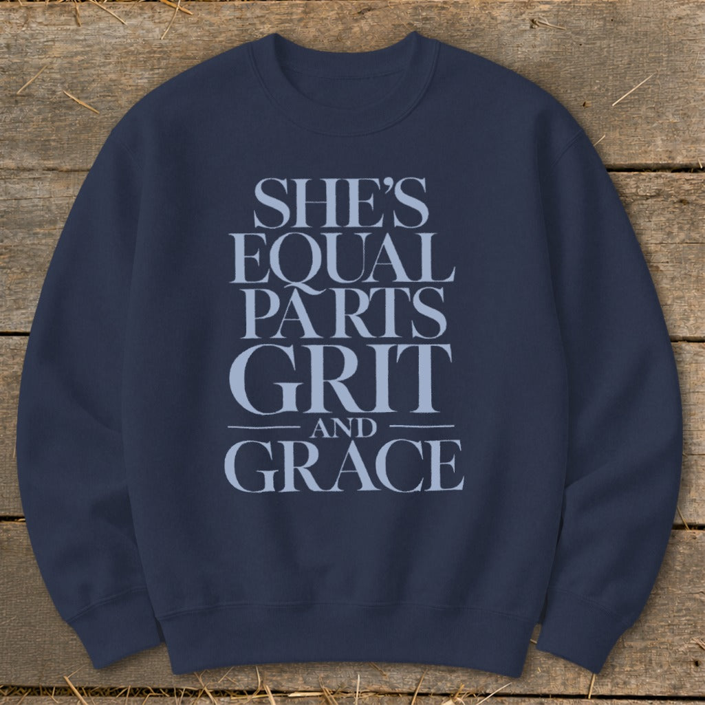 Navy sweatshirt with text "SHE'S EQUAL PARTS GRIT AND GRACE"