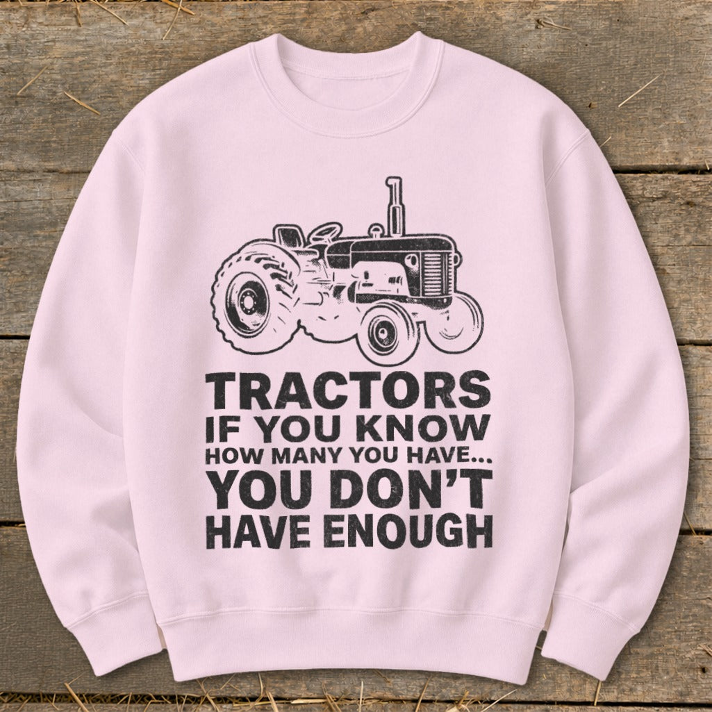 Pink sweatshirt with black graphic of a tractor and text "Tractors if you know how many you have... you don't have enough."