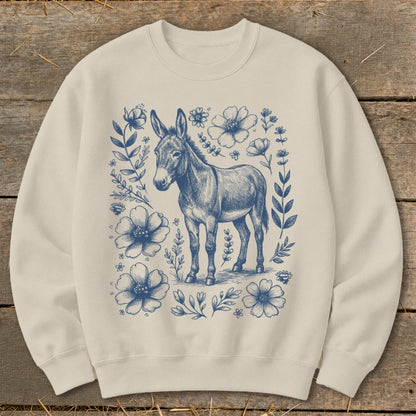 Cream sweatshirt with a blue sketched donkey and floral border design.