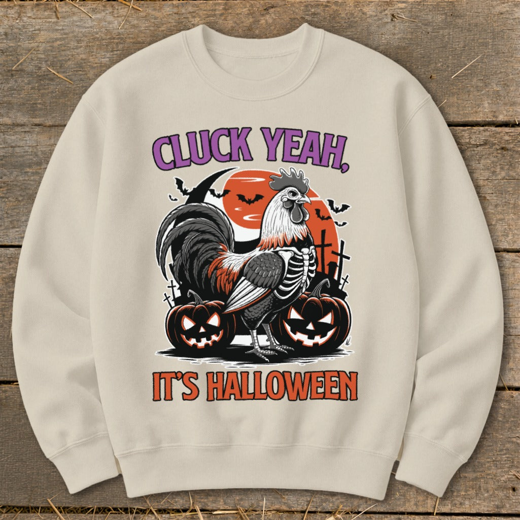 Beige sweatshirt with a rooster skeleton graphic and text "Cluck Yeah, It's Halloween".