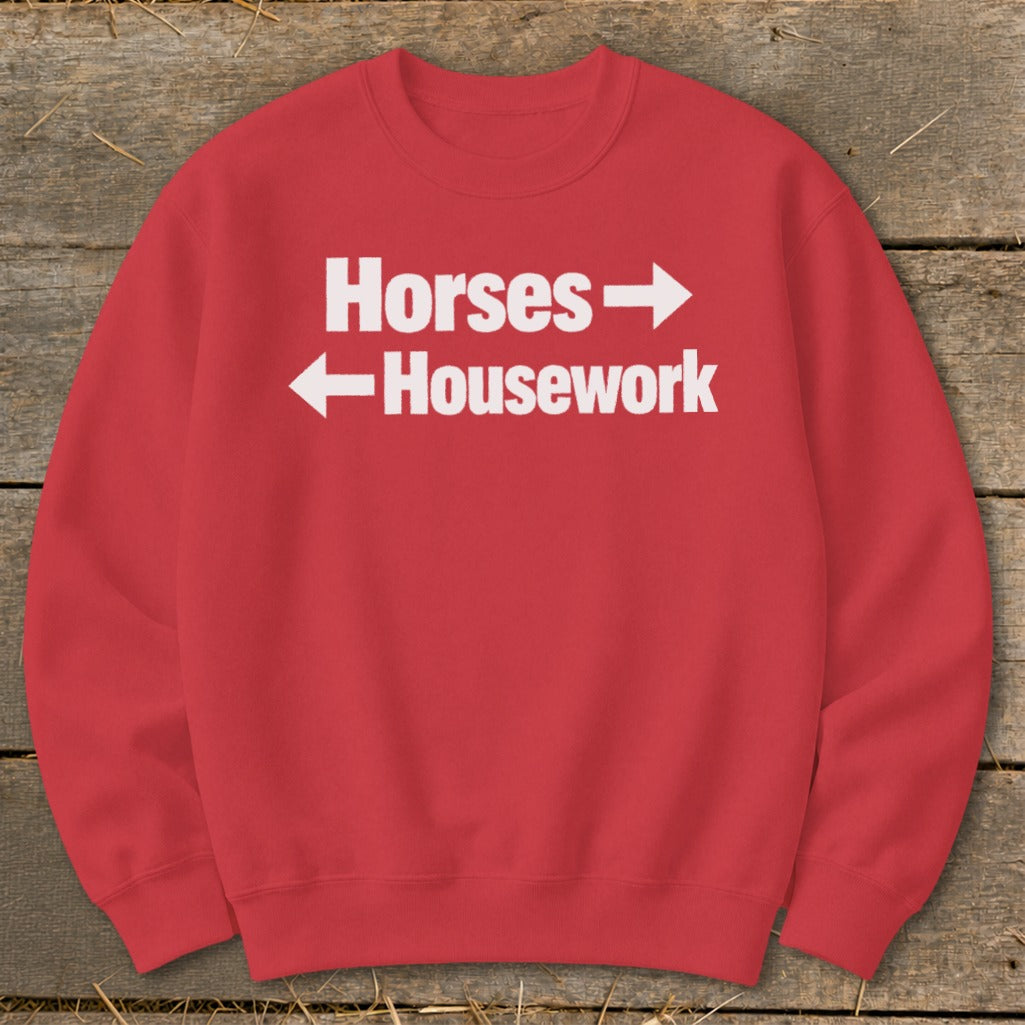 Red crewneck sweatshirt with white text reading Horses with a right arrow and Housework with a left arrow.