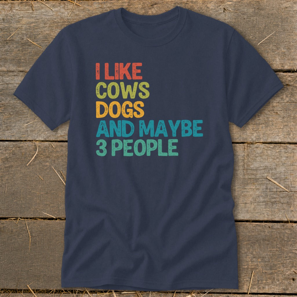 Navy t-shirt with "I LIKE COWS DOGS AND MAYBE 3 PEOPLE" in colorful text.