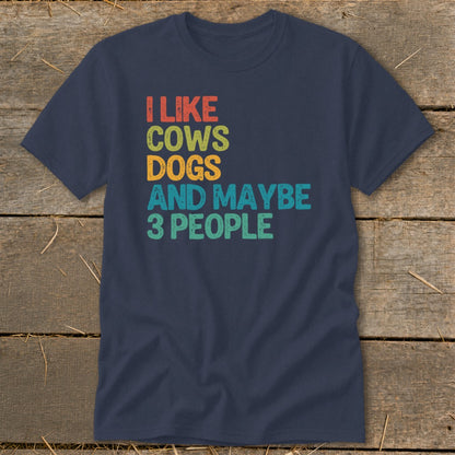 Navy t-shirt with "I LIKE COWS DOGS AND MAYBE 3 PEOPLE" in colorful text.
