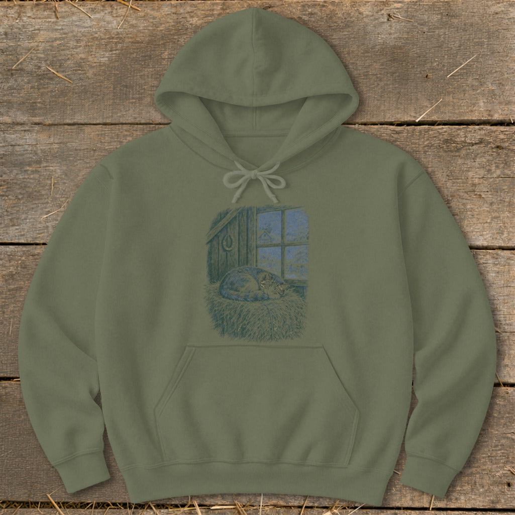 Olive green hoodie with print of a cat sleeping on hay by a barn window.