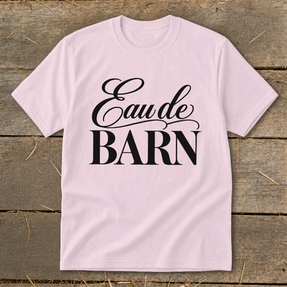 Pink t-shirt with black text "Eau de BARN" in script and block letters.