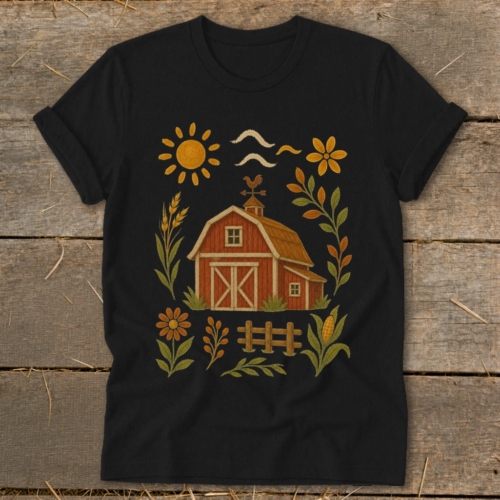 Black t-shirt with a rustic farm graphic featuring a red barn, sun, and flowers.