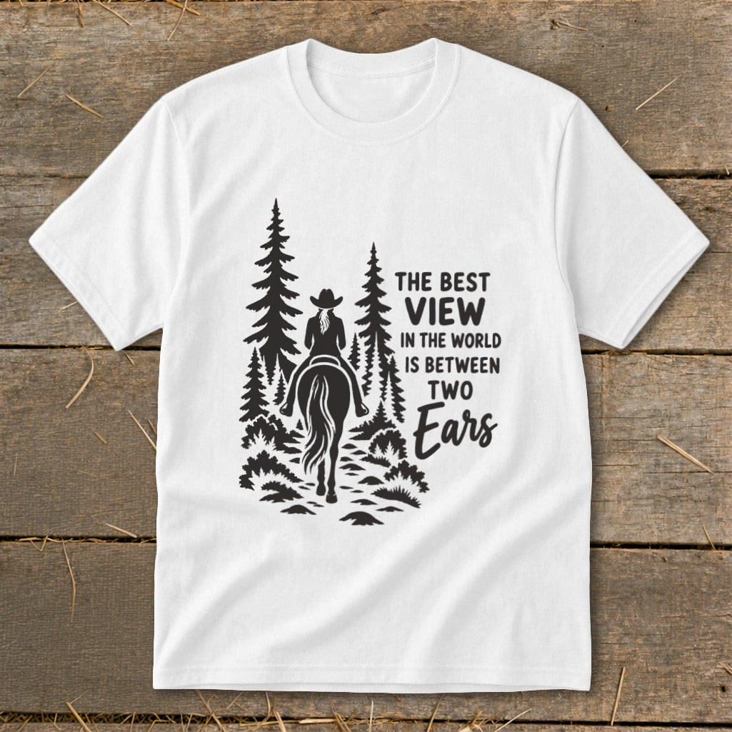 White t-shirt featuring a black graphic of a horseback rider amid pine trees with text.