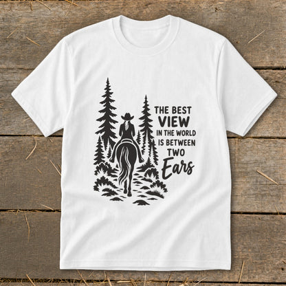 White t-shirt featuring a black graphic of a horseback rider amid pine trees with text.