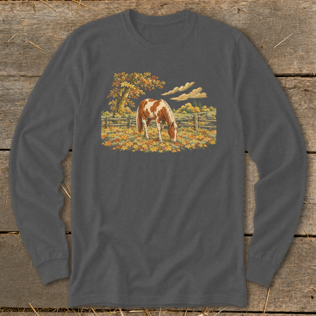 Long-sleeve t-shirt with a paint horse grazing in a field of autumn leaves.