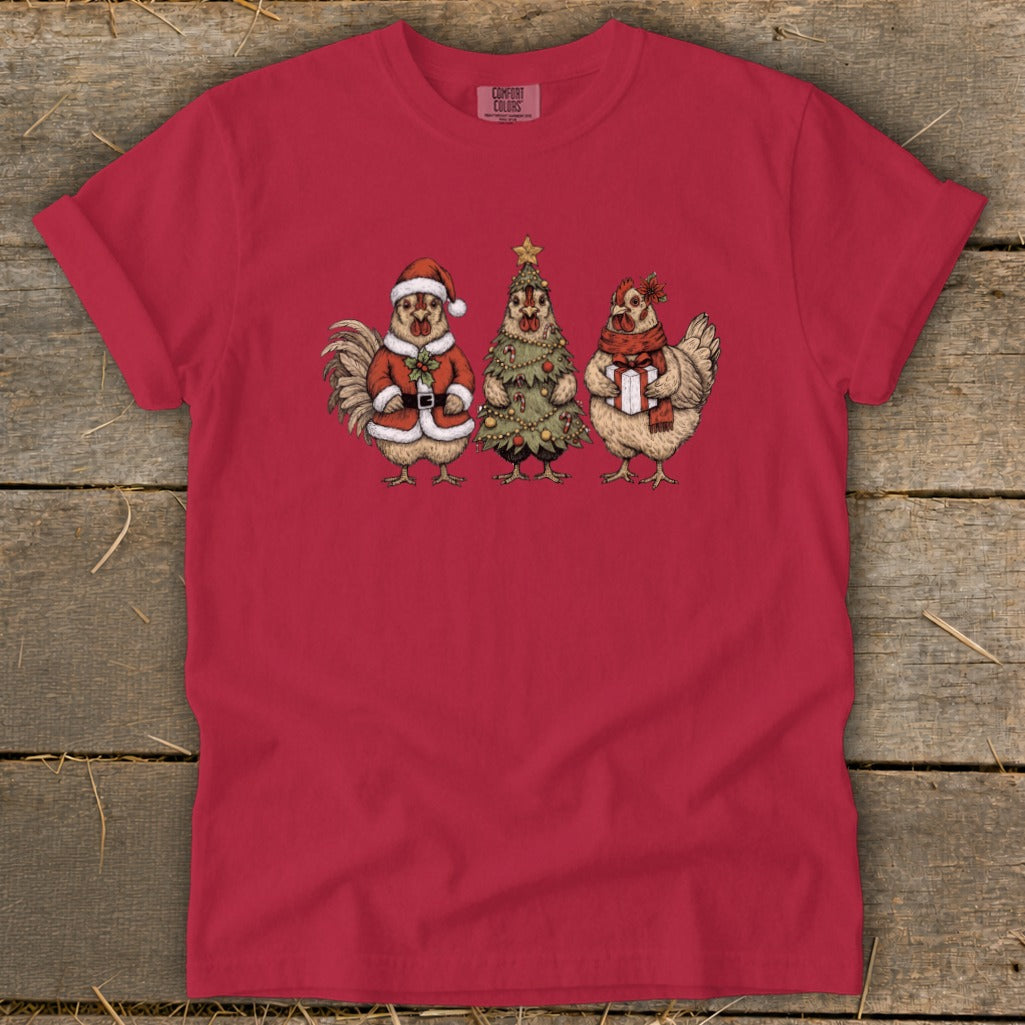Rooster in Santa suit, chicken dressed as Christmas tree, and chicken with gift.