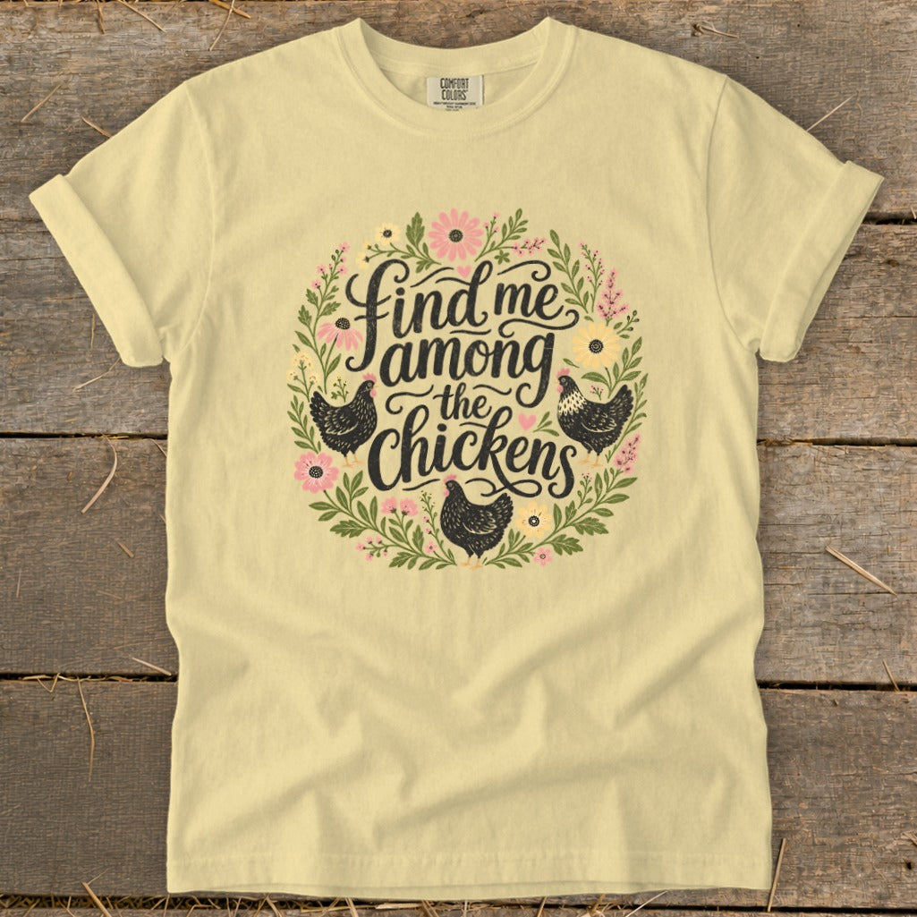Yellow t-shirt with "Find me among the chickens" text and floral chicken graphic.