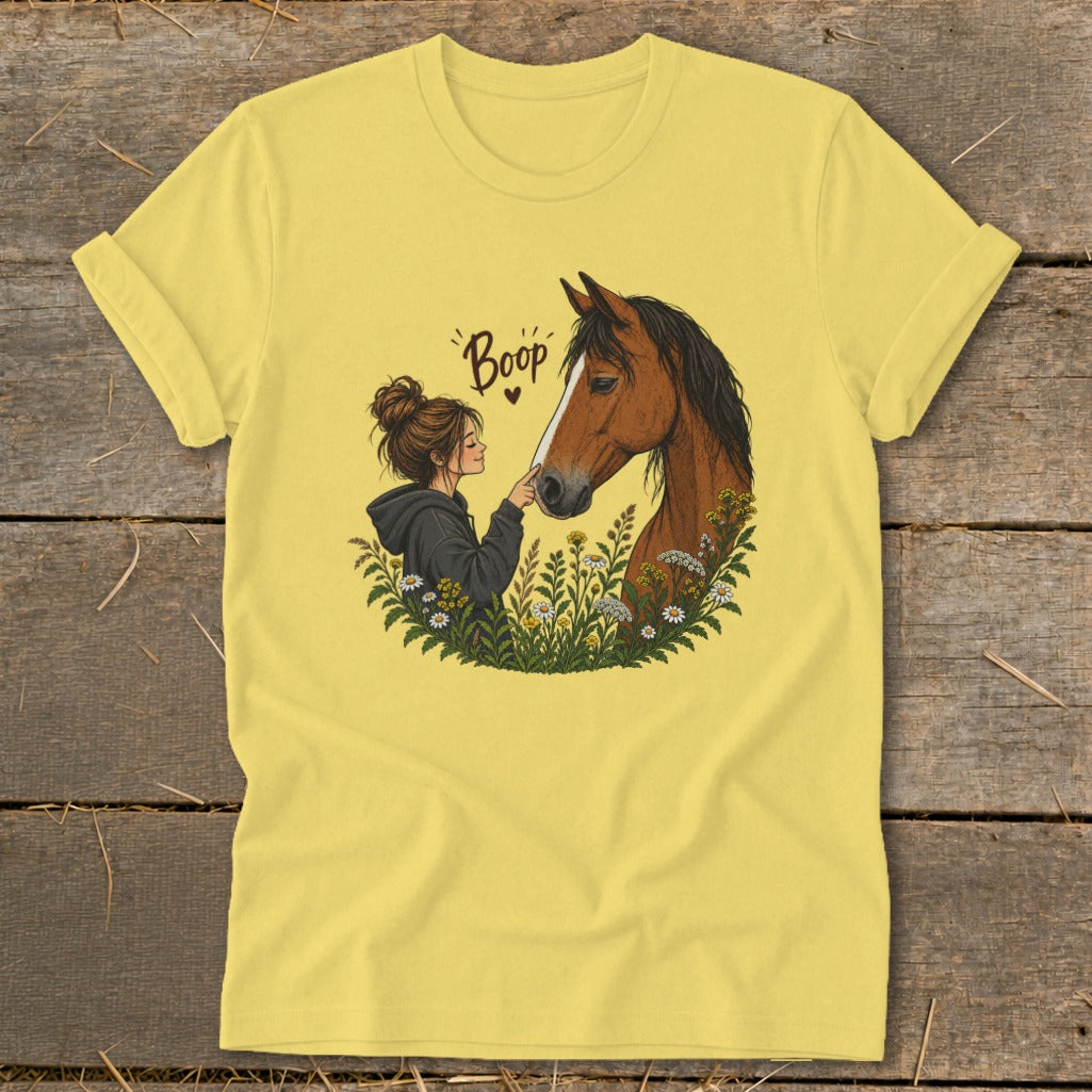 Yellow t-shirt with illustration of a girl touching a horse's nose with the word "Boop".