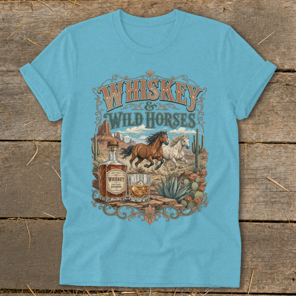 Whiskey and Wild Horses graphic with desert landscape, bottle, and glass on a t-shirt.