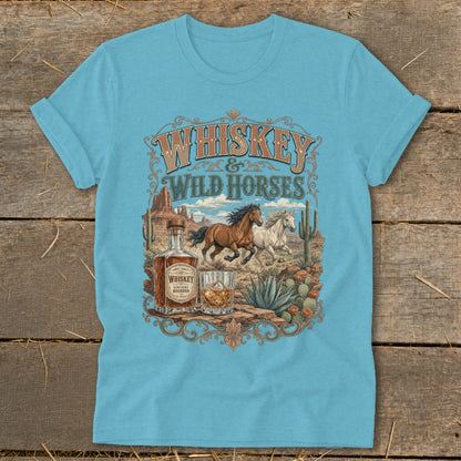 Whiskey and Wild Horses graphic with desert landscape, bottle, and glass on a t-shirt.