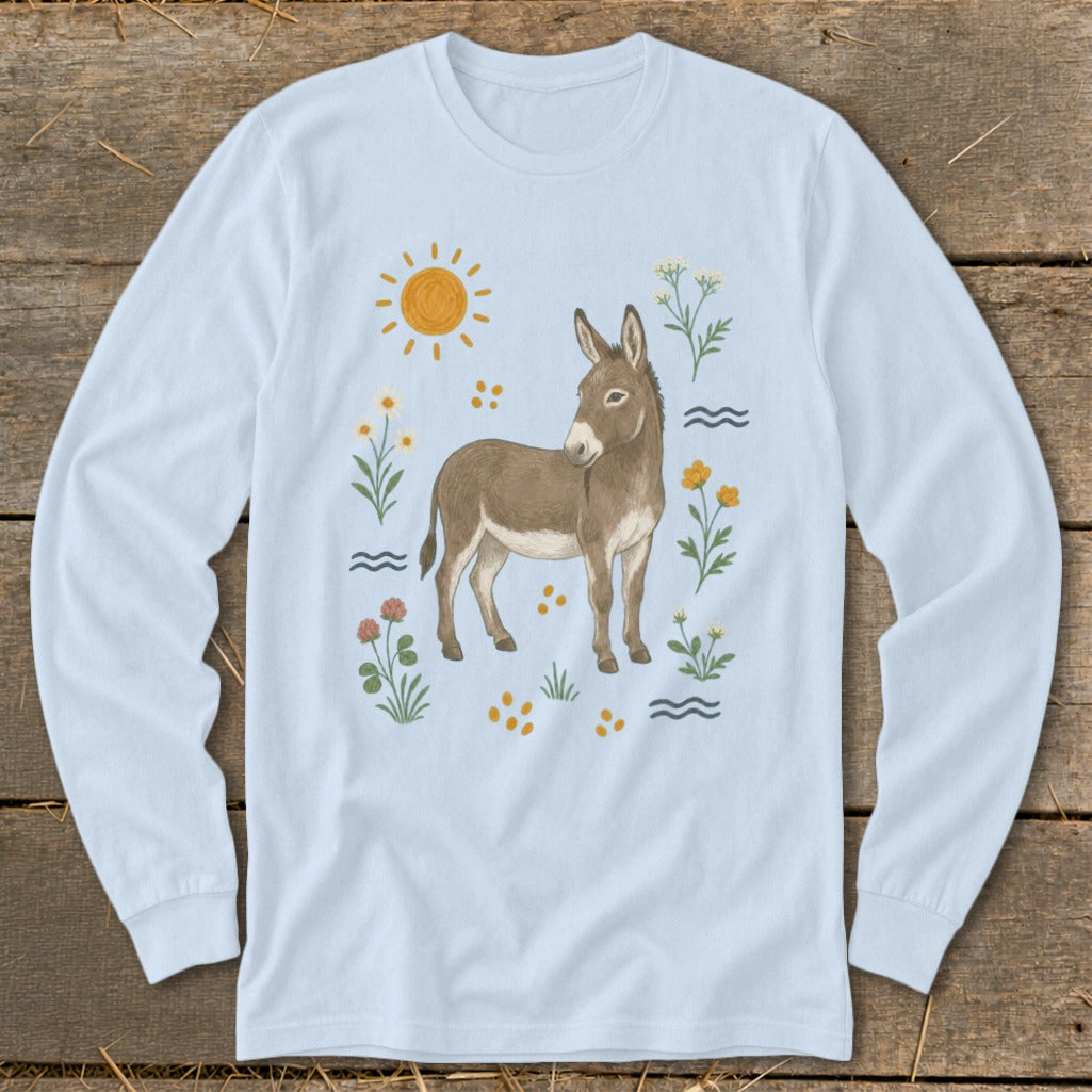 Donkey with sun, flowers, and wavy lines illustration on a light blue long-sleeve shirt.