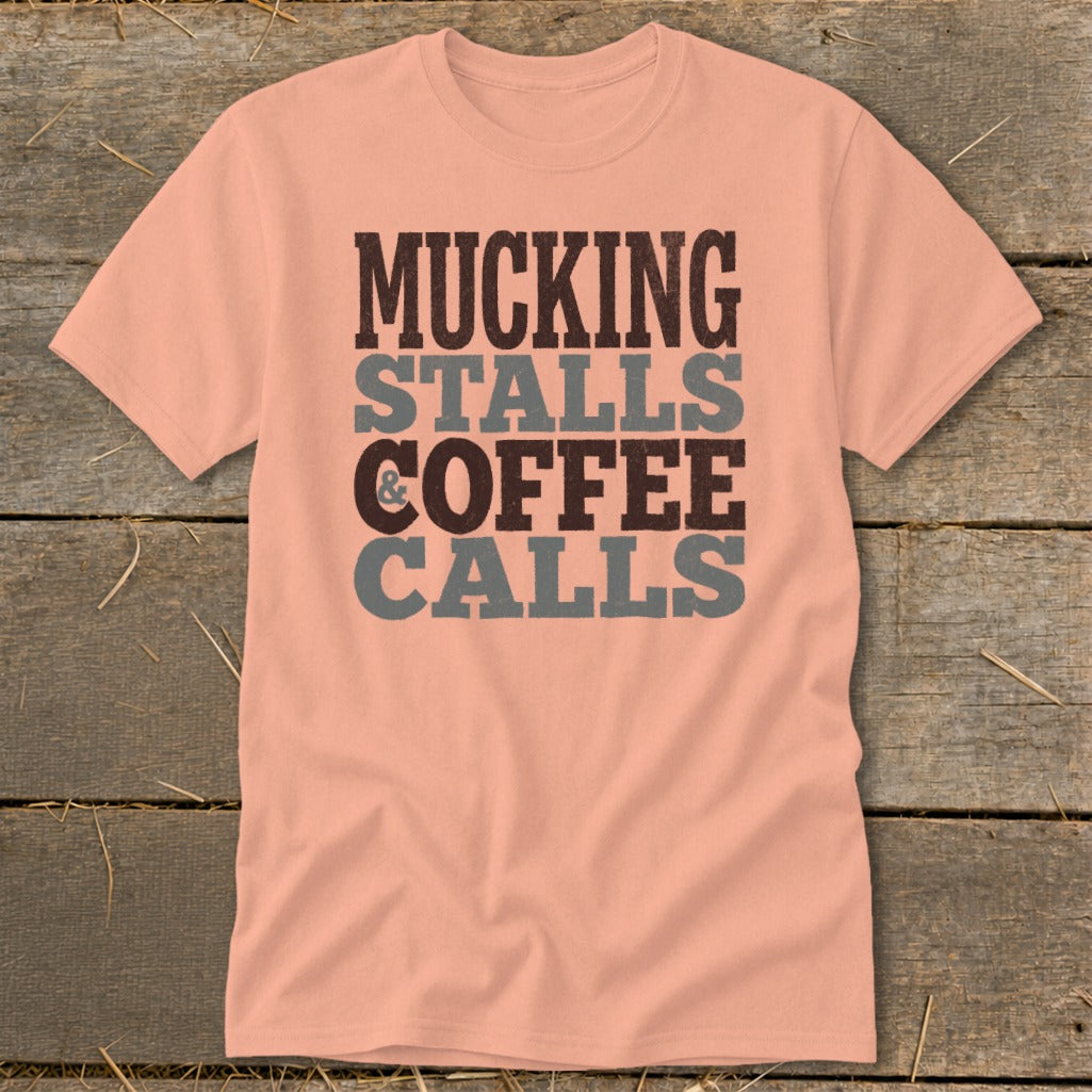 Peach t-shirt with "Mucking Stalls & Coffee Calls" graphic in distressed text.