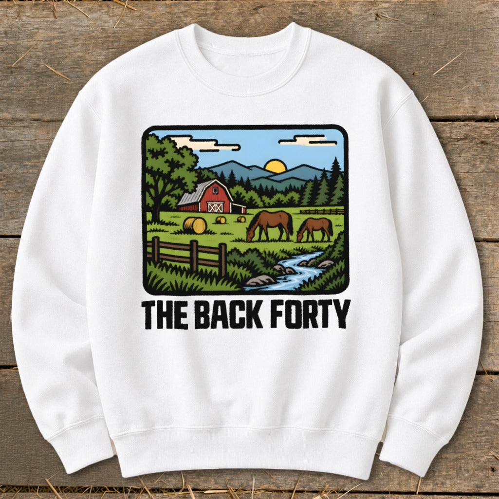 A white crewneck sweatshirt featuring a graphic of a rural farm scene and the text THE BACK FORTY.