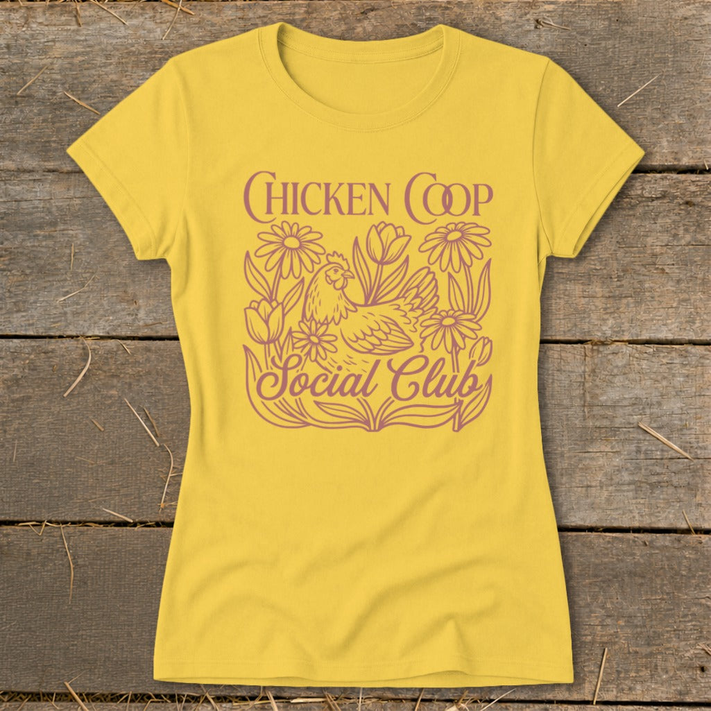 Yellow t-shirt with "Chicken Coop Social Club" text and chicken with flowers graphic.