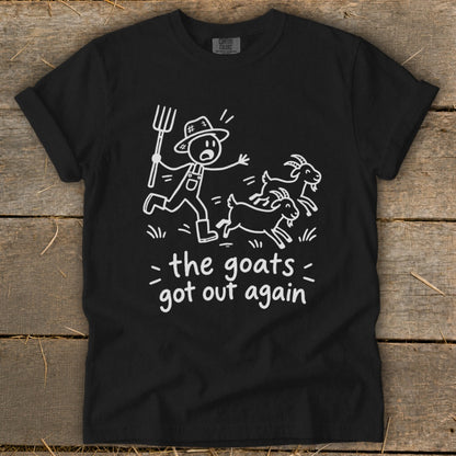 Black t-shirt with white graphic of farmer chasing goats and text "the goats got out again".
