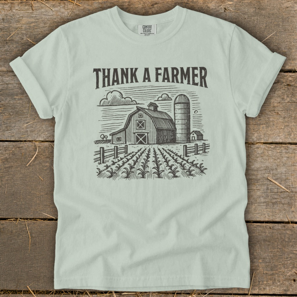 Light blue t-shirt with "Thank a Farmer" text and barn sketch.