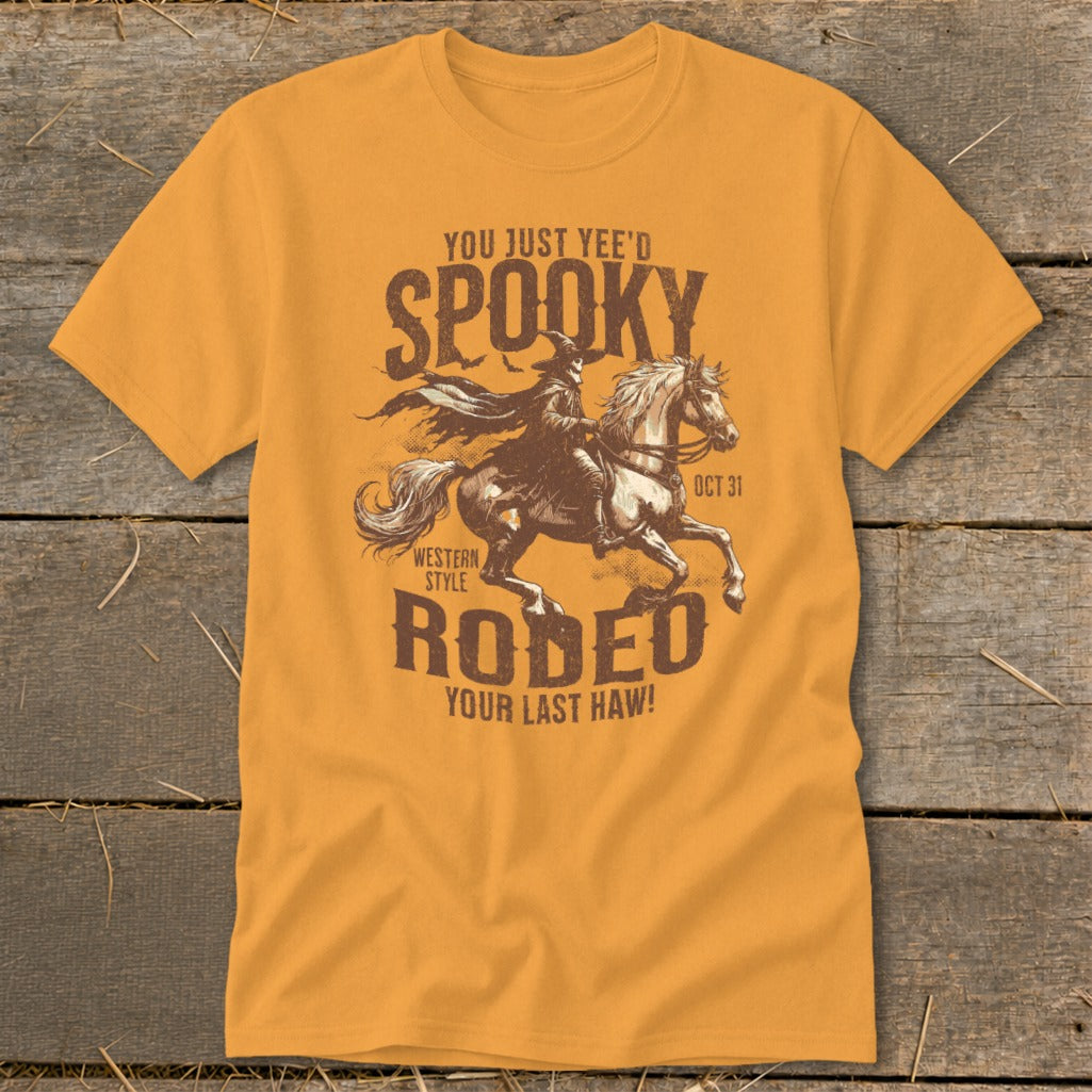 Orange t-shirt with "Spooky Rodeo" graphic and text "You Just Yee'd", "Oct 31", "Western Style", "Your Last Haw!".