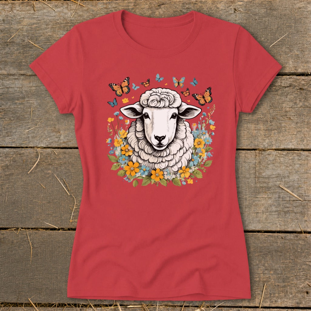Red t-shirt with graphic of a sheep surrounded by colorful flowers and butterflies.