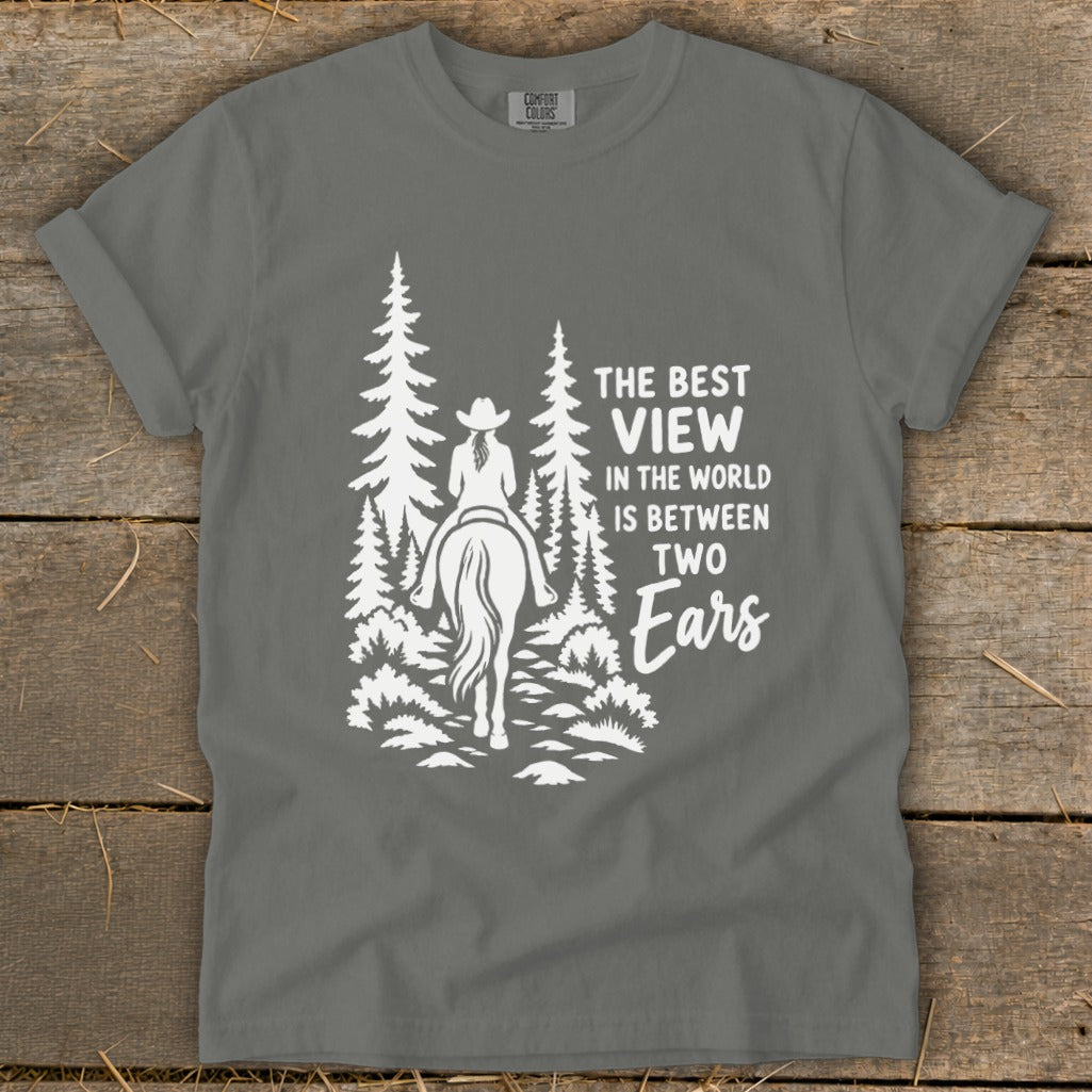 A grey t-shirt featuring a white graphic of a horseback rider in the woods with text.