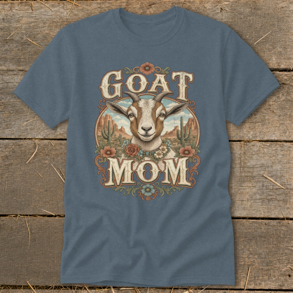Goat Mom graphic on a blue t-shirt with desert scene and floral accents.