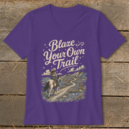 Purple t-shirt with "Blaze Your Own Trail" text and a cowboy riding a horse on a desert path.