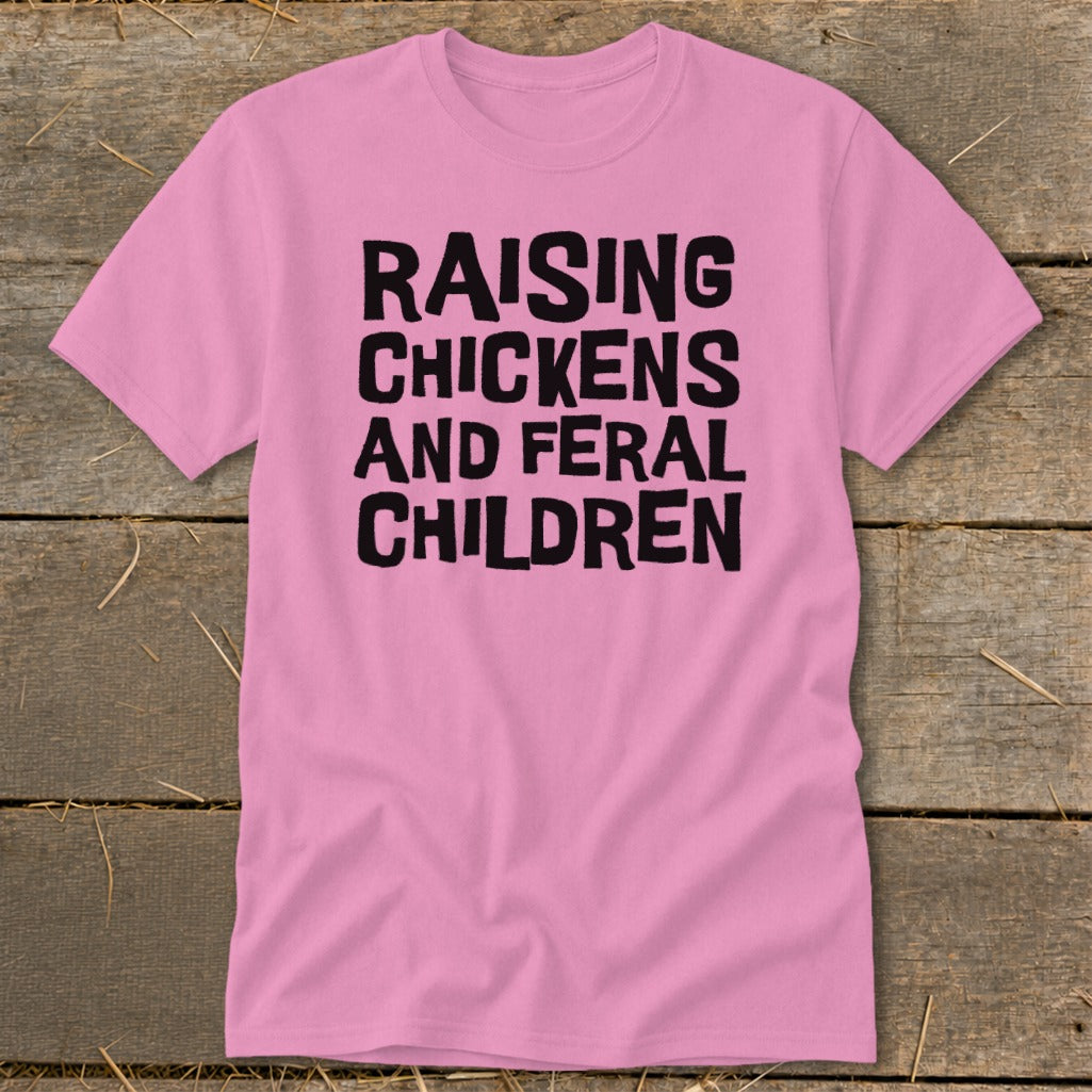 Pink t-shirt with black text reading "Raising Chickens and Feral Children".