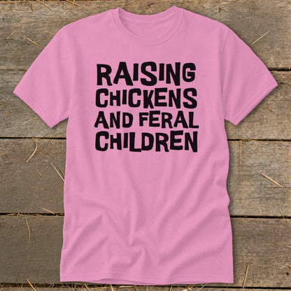 Pink t-shirt with black text reading "Raising Chickens and Feral Children".
