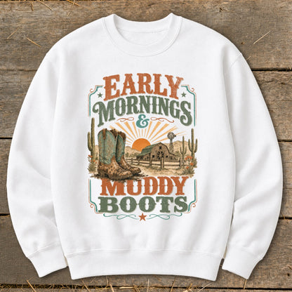 White sweatshirt with "Early Mornings & Muddy Boots" graphic featuring cowboy boots, barn, and windmill.