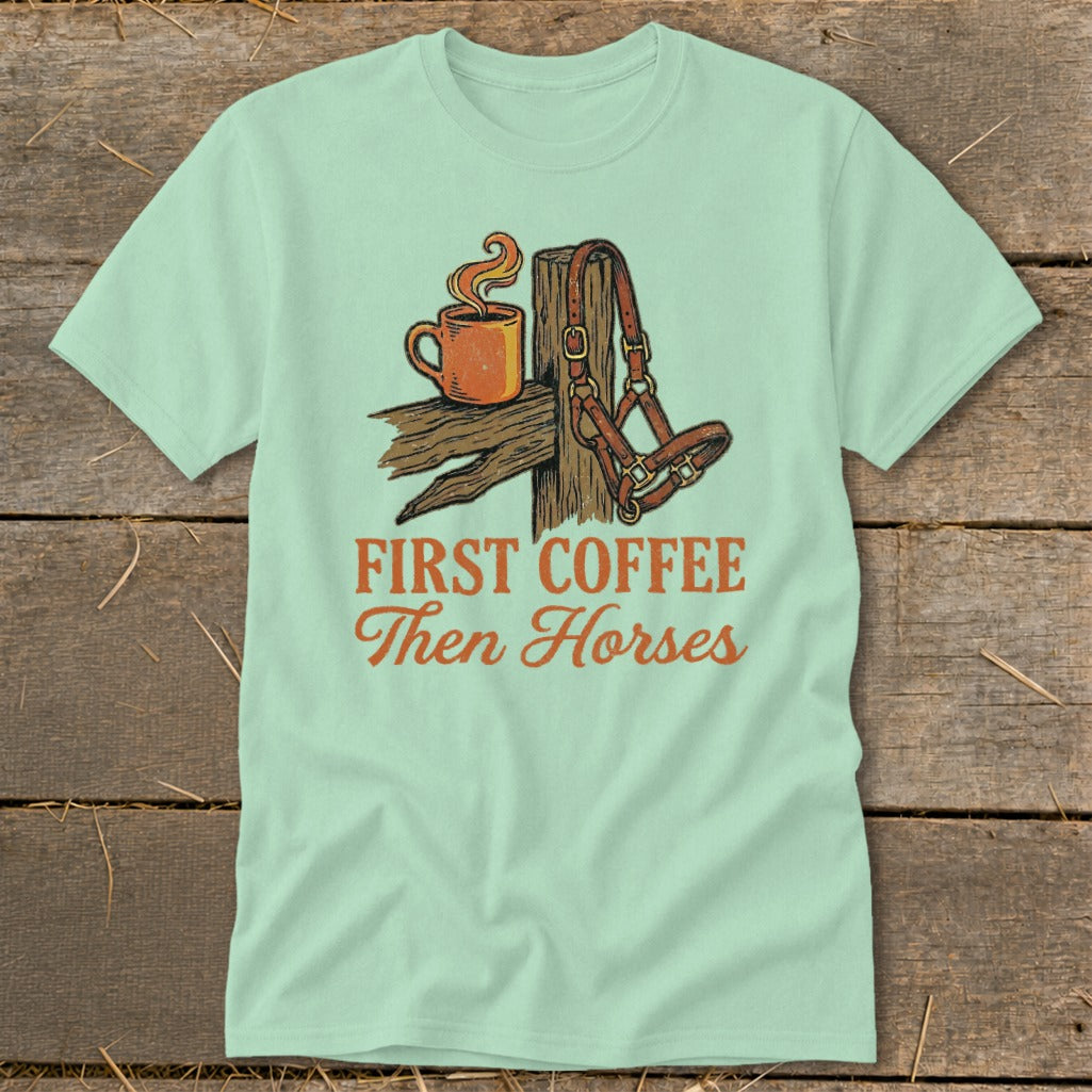 Graphic tee with coffee cup and horse halter, reads "First Coffee Then Horses".