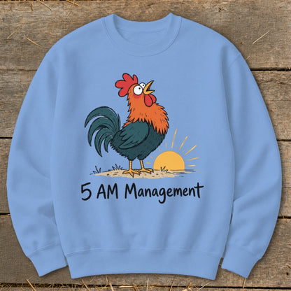 Light blue sweatshirt with cartoon rooster crowing at sunrise, "5 AM Management" text.
