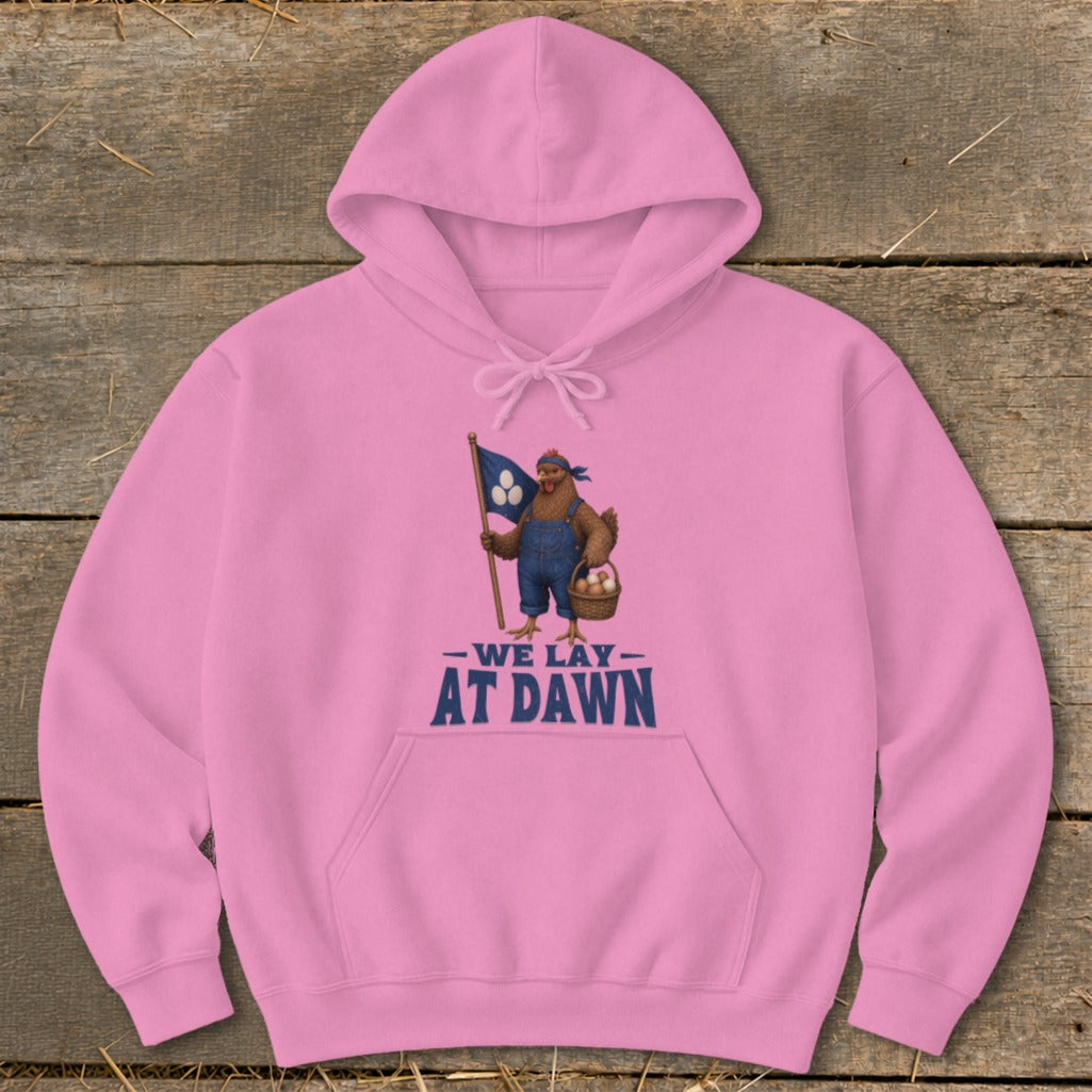Pink hoodie with a chicken holding a flag and basket of eggs, text reads "WE LAY AT DAWN".