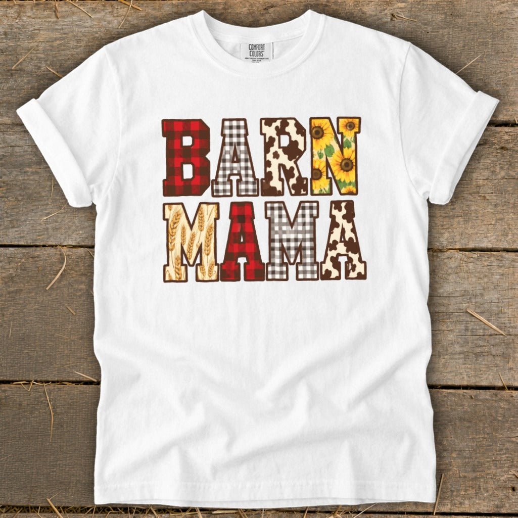 White t-shirt with "BARN MAMA" text featuring buffalo plaid, cow print, sunflowers, and wheat.