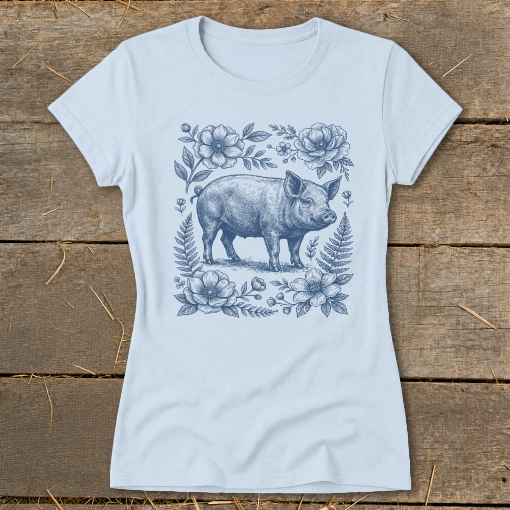 Light blue t-shirt with a detailed blue ink drawing of a pig surrounded by flowers.
