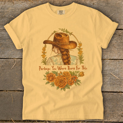 Yellow t-shirt with illustration of a woman in a cowboy hat and text "Perhaps You Were Born For This".