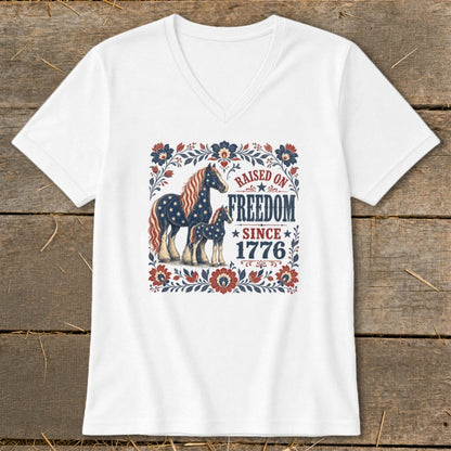 White t-shirt with horses and "Raised on Freedom Since 1776" text.