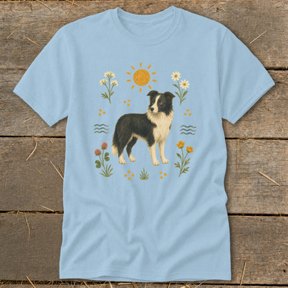 Light blue t-shirt with a standing Border Collie dog surrounded by sun, flowers, and waves.