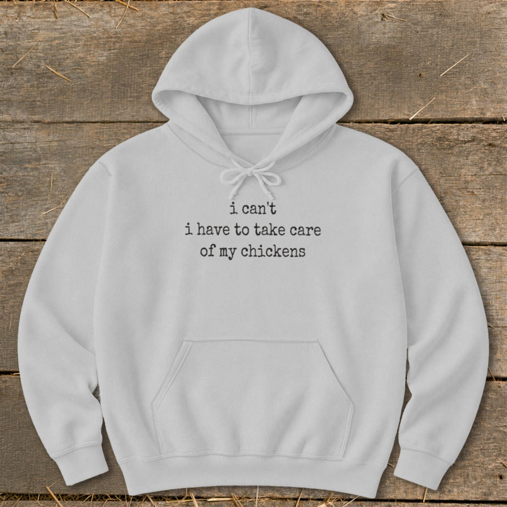 White hoodie with black text that reads "i can't i have to take care of my chickens".