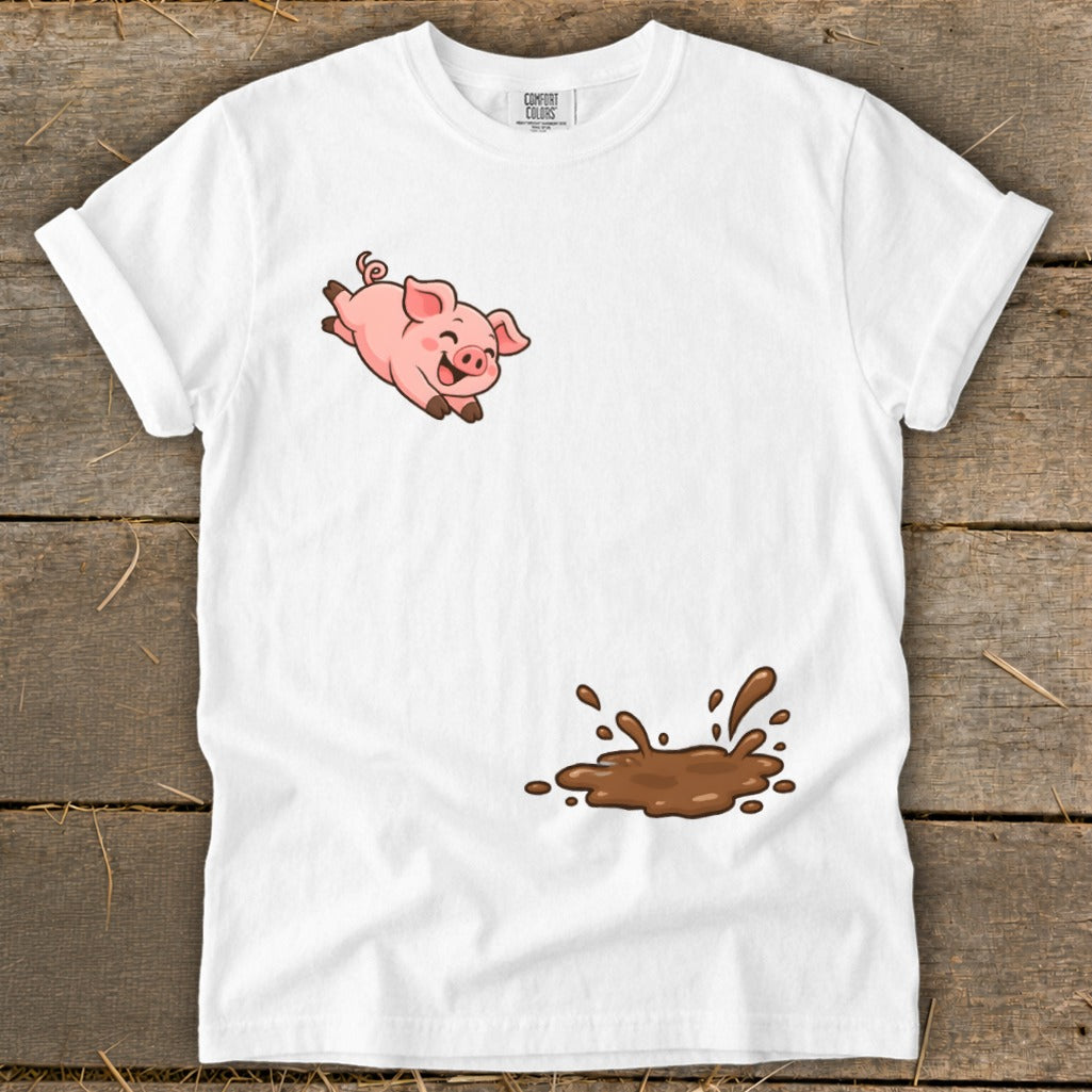 White t-shirt with cartoon pig jumping over a mud puddle graphic.
