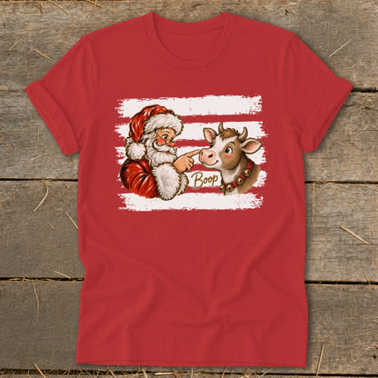 Santa boops a cow with the word "Boop" on a red shirt with white stripes.