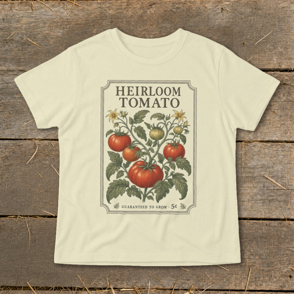Cream t-shirt with vintage "Heirloom Tomato" illustration of a tomato plant and "Guaranteed to Grow" text.